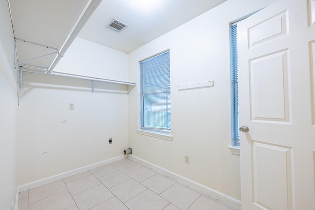 5003 Lord Rd, Crosby, TX 77532 - laundry room with laundry area, visible vents, light tile patterned floors, hookup for an electric dryer, and baseboards
