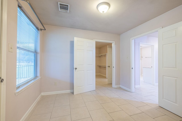 5003 Lord Rd, Crosby, TX 77532 - unfurnished bedroom featuring a spacious closet, visible vents, light tile patterned floors, a closet, and baseboards