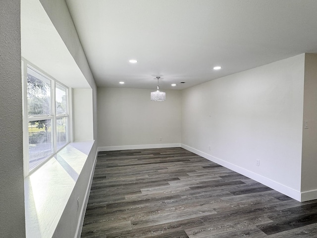 5814 W Bellfort Ave, Houston, TX 77035 - empty room featuring baseboards, a notable chandelier, dark wood-style floors, and recessed lighting