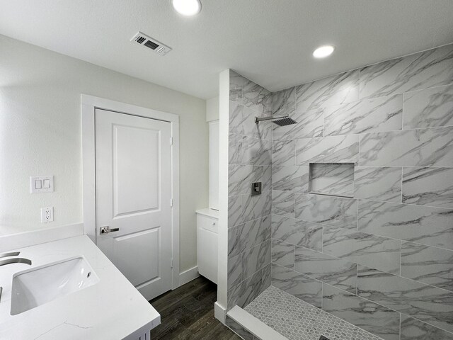 5814 W Bellfort Ave, Houston, TX 77035 - full bathroom featuring recessed lighting, a tile shower, visible vents, vanity, and baseboards
