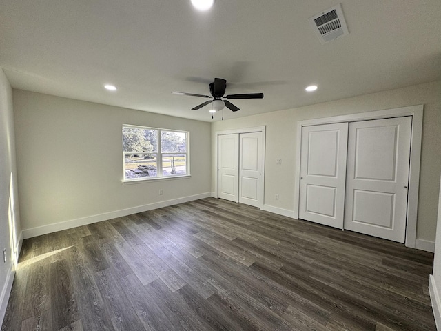 5814 W Bellfort Ave, Houston, TX 77035 - unfurnished bedroom with dark wood-style flooring, multiple closets, visible vents, and recessed lighting