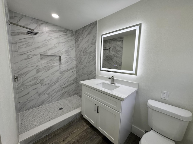 5814 W Bellfort Ave, Houston, TX 77035 - full bath with toilet, vanity, wood finished floors, and tiled shower