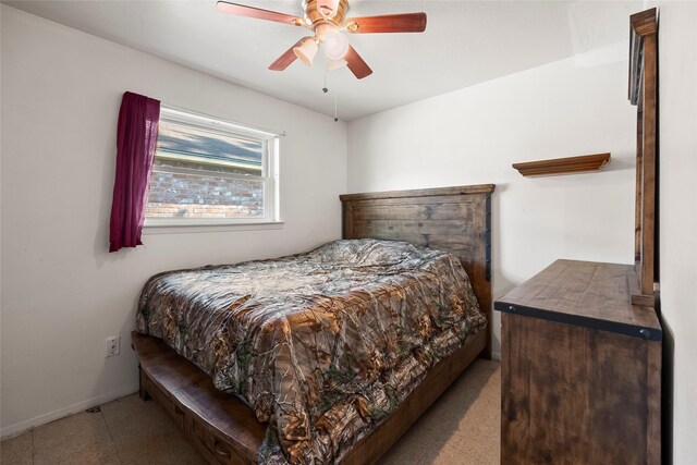 bedroom with a ceiling fan and baseboards