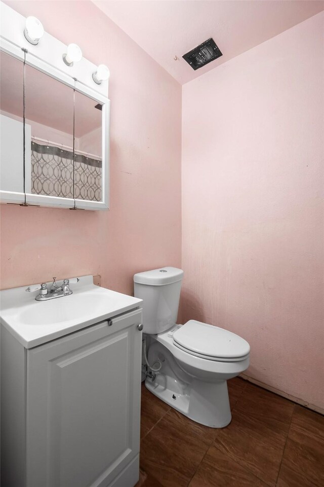 full bathroom with vanity, tile patterned flooring, and toilet