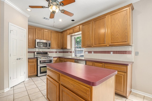15242 Shapiro Springs Ln, Houston, TX 77095 - kitchen featuring stainless steel appliances, light tile patterned floors, decorative backsplash, a sink, and crown molding