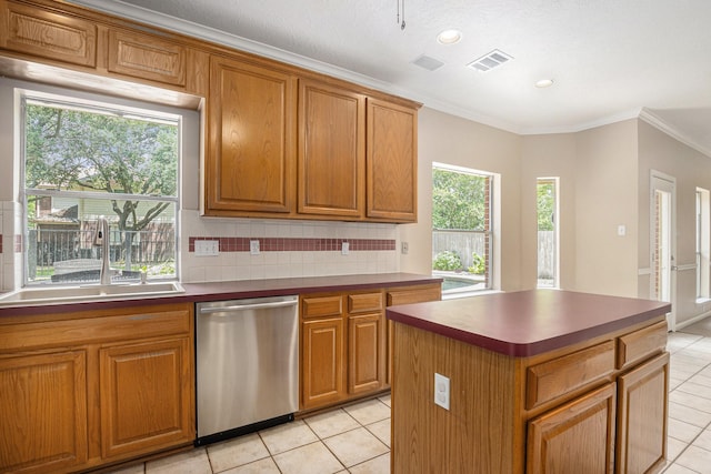 15242 Shapiro Springs Ln, Houston, TX 77095 - kitchen featuring stainless steel dishwasher, a sink, light tile patterned floors, backsplash, and crown molding