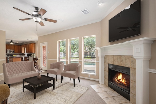 15242 Shapiro Springs Ln, Houston, TX 77095 - living room with ceiling fan, a tiled fireplace, baseboards, ornamental molding, and recessed lighting