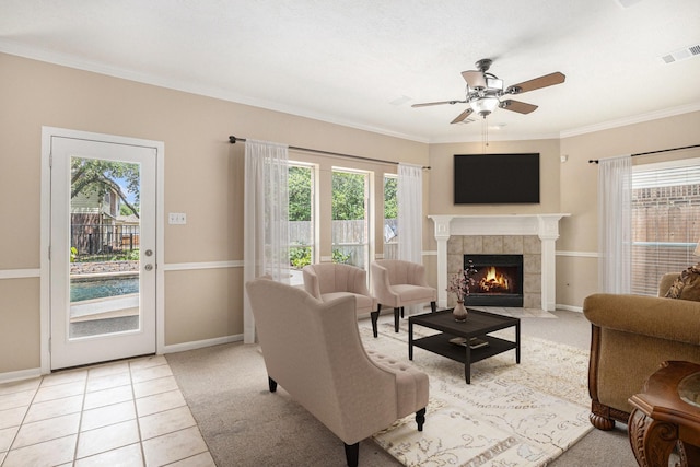 15242 Shapiro Springs Ln, Houston, TX 77095 - living room featuring healthy amount of natural light, a ceiling fan, ornamental molding, a tile fireplace, and baseboards