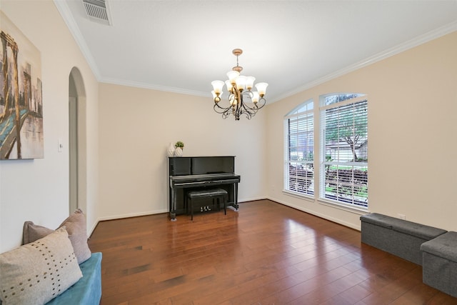 2513 Garnetfield Ln, Friendswood, TX 77546 - living area featuring ornamental molding, wood finished floors, arched walkways, a chandelier, and baseboards
