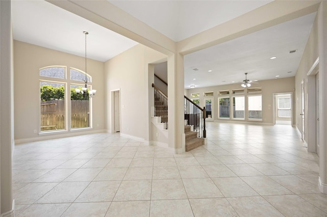 interior space featuring stairs, light tile patterned flooring, and plenty of natural light