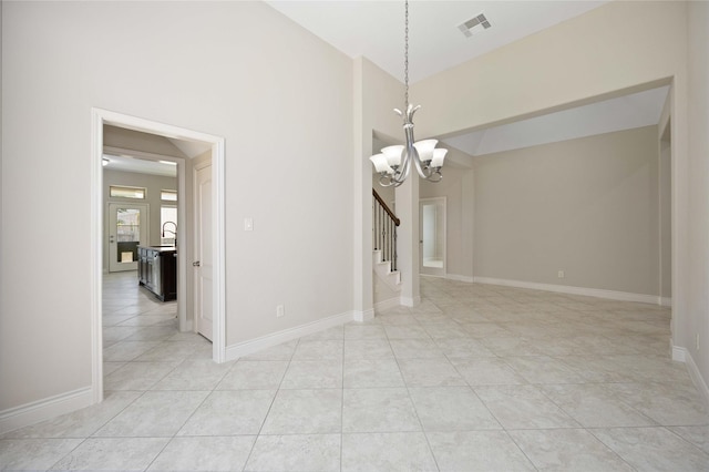 unfurnished dining area featuring visible vents, an inviting chandelier, baseboards, stairway, and light tile patterned floors