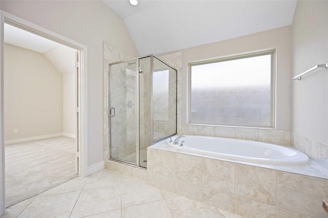 full bathroom with a stall shower, tile patterned floors, lofted ceiling, and a garden tub