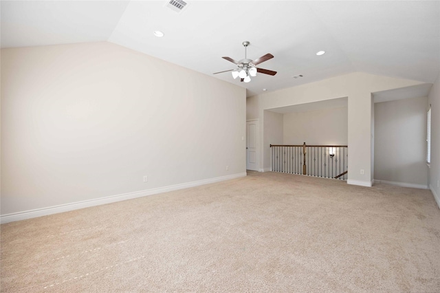 unfurnished room featuring visible vents, light colored carpet, ceiling fan, and lofted ceiling