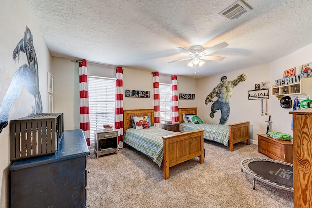 carpeted bedroom with a ceiling fan, a textured ceiling, and visible vents