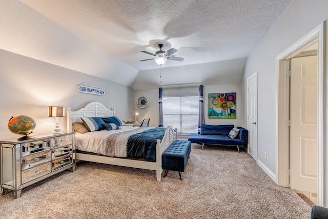 bedroom with vaulted ceiling, a textured ceiling, ceiling fan, and light carpet