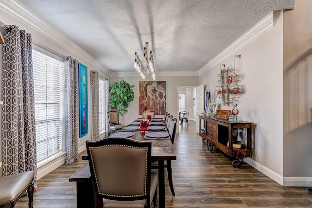 dining room featuring a textured ceiling, a healthy amount of sunlight, crown molding, and baseboards