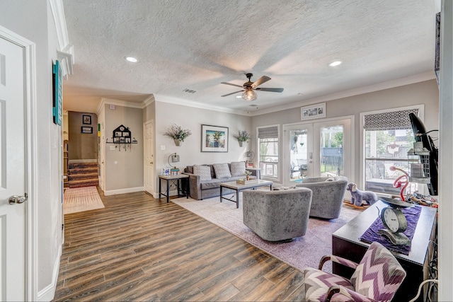 living area featuring wood finished floors, a ceiling fan, french doors, a textured ceiling, and stairs