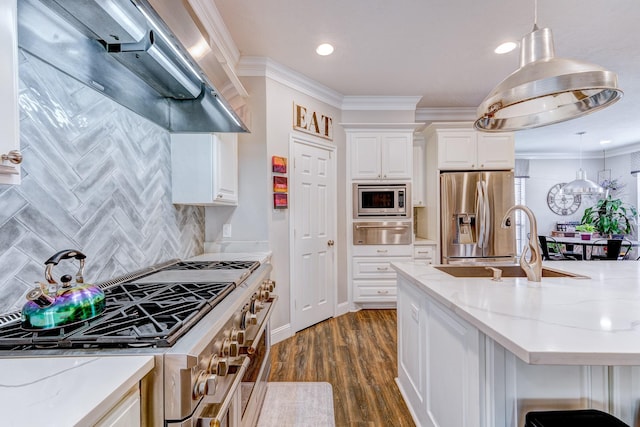 kitchen featuring tasteful backsplash, a warming drawer, stainless steel appliances, white cabinets, and wall chimney exhaust hood