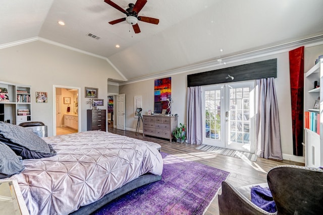 bedroom featuring lofted ceiling, wood finished floors, ornamental molding, and visible vents