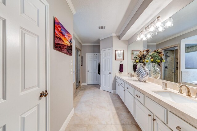 bathroom featuring double vanity, a shower stall, visible vents, and a sink