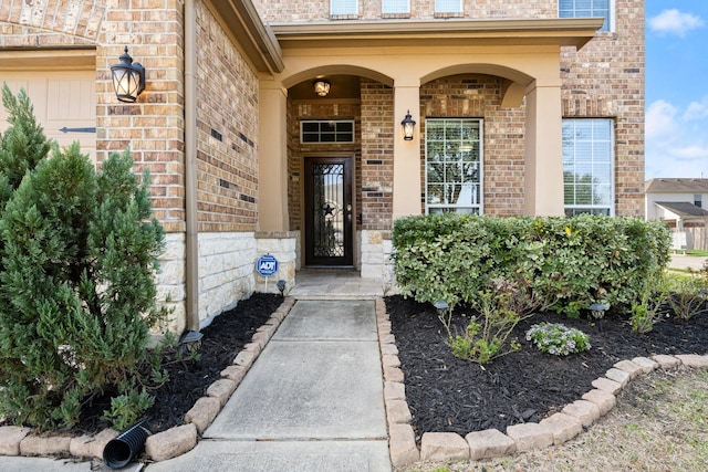 doorway to property with brick siding
