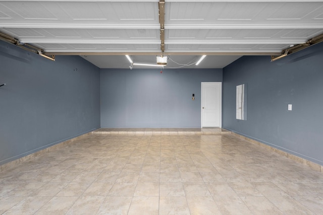 garage featuring a garage door opener and baseboards
