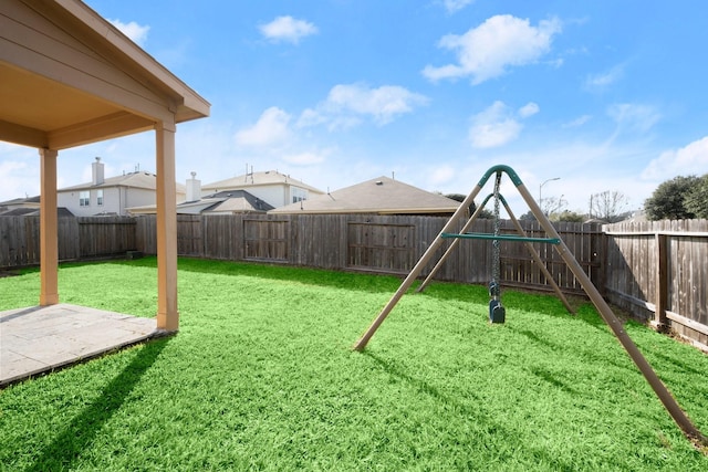 view of yard with a fenced backyard and a playground