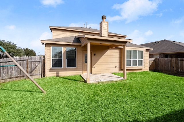 rear view of house featuring a fenced backyard, a chimney, a patio, and a lawn