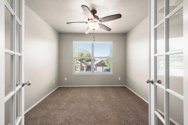 unfurnished room with carpet, baseboards, ceiling fan, and french doors