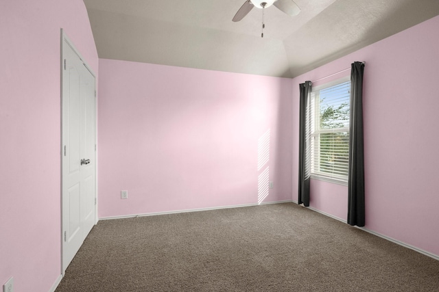 carpeted empty room with baseboards, ceiling fan, and lofted ceiling