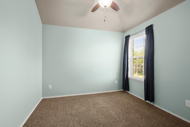 spare room featuring lofted ceiling, carpet, a ceiling fan, and baseboards
