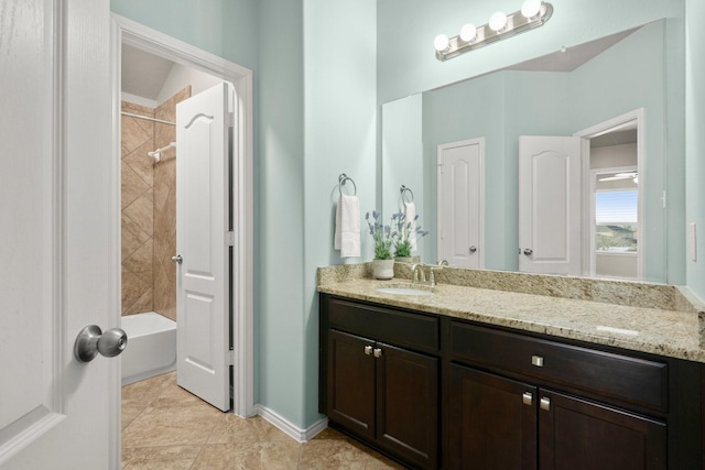 full bathroom featuring tile patterned flooring, baseboards, vanity, and  shower combination