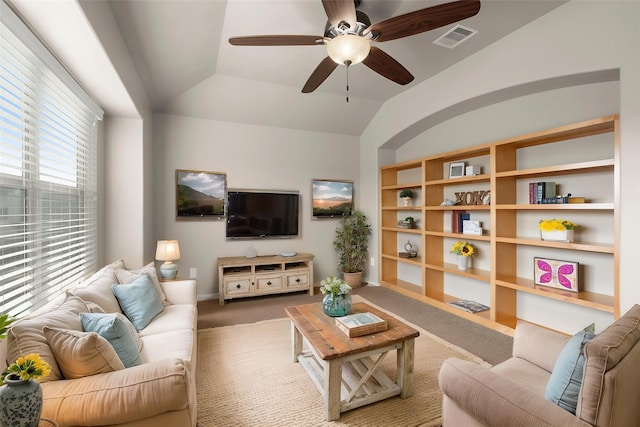 living room with vaulted ceiling, a ceiling fan, baseboards, carpet flooring, and visible vents