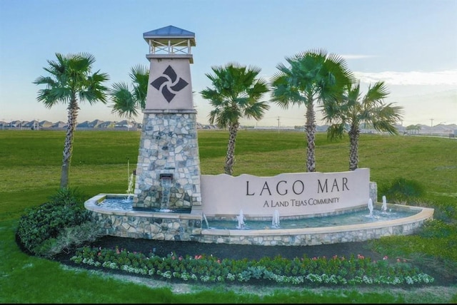 community / neighborhood sign with a lawn