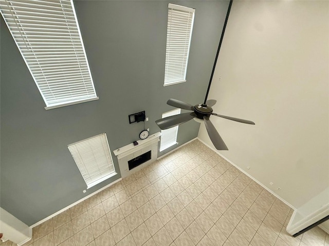 interior space featuring baseboards and ceiling fan