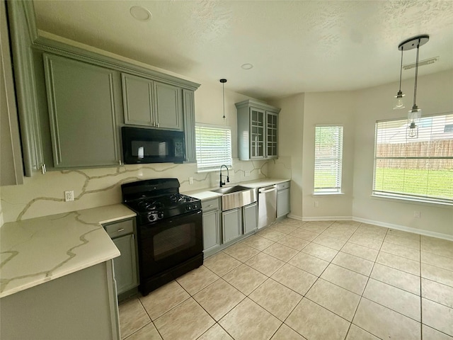 kitchen with visible vents, light tile patterned floors, a sink, decorative backsplash, and black appliances