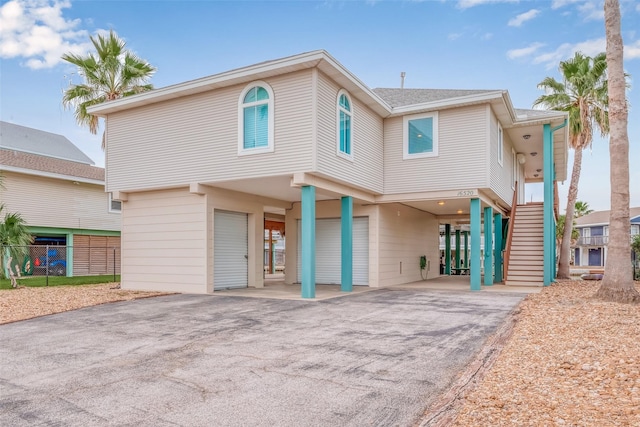 16520 Barbados Way, Jamaica Beach, TX 77554 - view of front of property featuring driveway, a carport, stairs, and fence