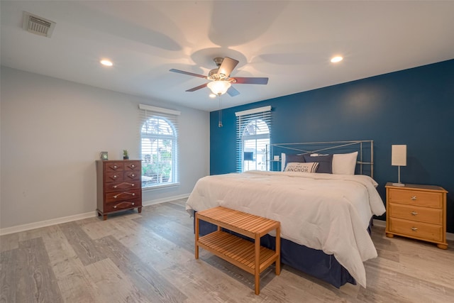 16520 Barbados Way, Jamaica Beach, TX 77554 - bedroom with ceiling fan, baseboards, light wood-style floors, and visible vents