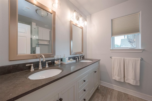16520 Barbados Way, Jamaica Beach, TX 77554 - bathroom featuring double vanity, visible vents, baseboards, and a sink