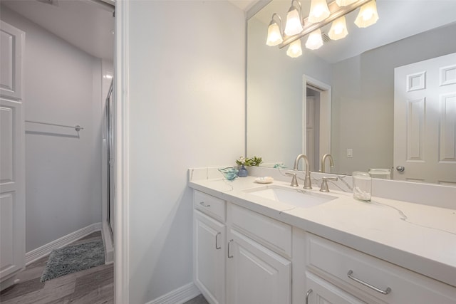16520 Barbados Way, Jamaica Beach, TX 77554 - bathroom featuring a shower with curtain, baseboards, a notable chandelier, wood finished floors, and vanity