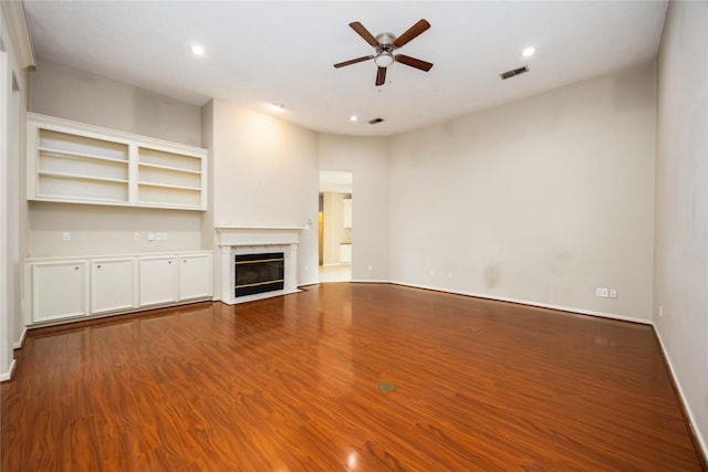 24526 Haigshire Dr, Tomball, TX 77375 - unfurnished living room featuring a ceiling fan, dark wood-type flooring, a high end fireplace, and recessed lighting