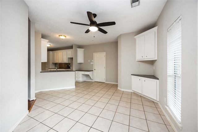 24526 Haigshire Dr, Tomball, TX 77375 - kitchen with dark countertops, ceiling fan, and white cabinets