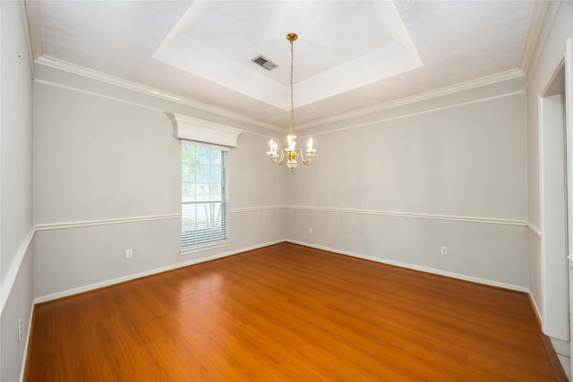 24526 Haigshire Dr, Tomball, TX 77375 - unfurnished room featuring a chandelier, wood finished floors, a tray ceiling, and ornamental molding