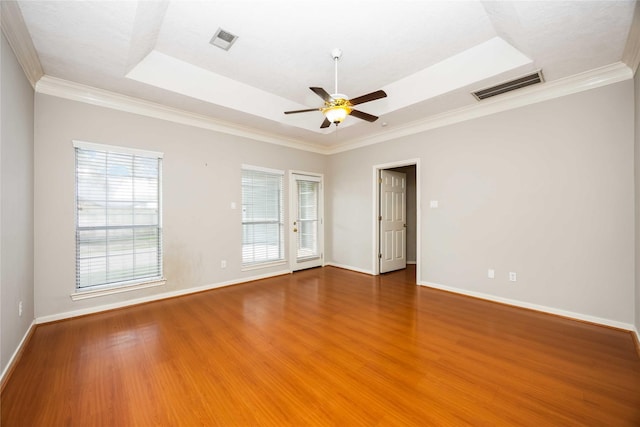 24526 Haigshire Dr, Tomball, TX 77375 - unfurnished room featuring a raised ceiling, wood finished floors, a ceiling fan, and ornamental molding