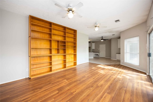 24526 Haigshire Dr, Tomball, TX 77375 - unfurnished living room with wood finished floors and ceiling fan