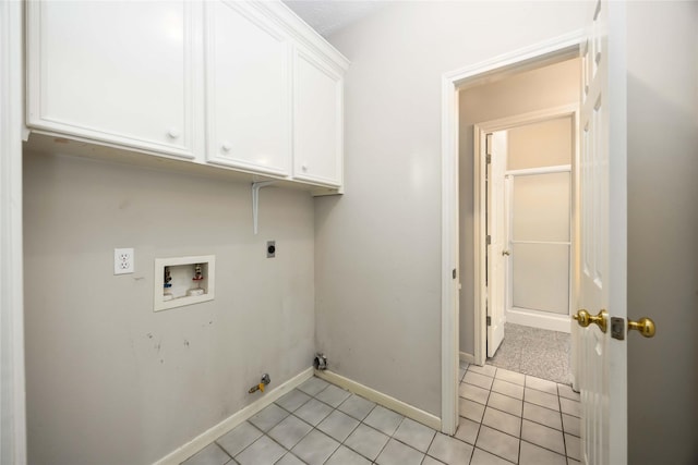 24526 Haigshire Dr, Tomball, TX 77375 - laundry area with hookup for an electric dryer, hookup for a washing machine, cabinet space, light tile patterned flooring, and hookup for a gas dryer