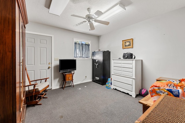 bedroom with a ceiling fan, baseboards, carpet, and a textured ceiling