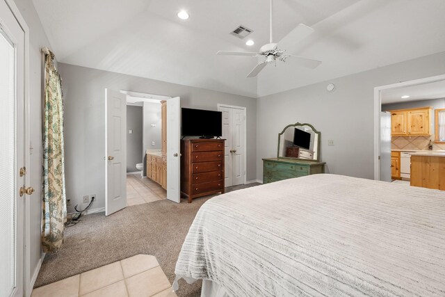 bedroom featuring ensuite bathroom, light colored carpet, baseboards, visible vents, and recessed lighting