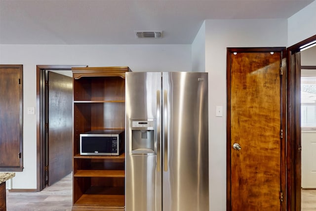 kitchen featuring stainless steel appliances, light wood-type flooring, visible vents, open shelves, and light stone countertops