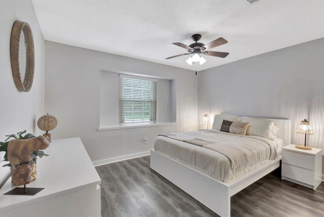 bedroom with baseboards, wood finished floors, and ceiling fan